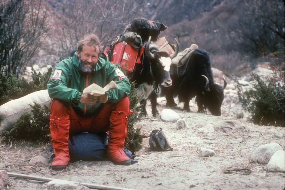 Chris reading with yaks Menlungtse 1987