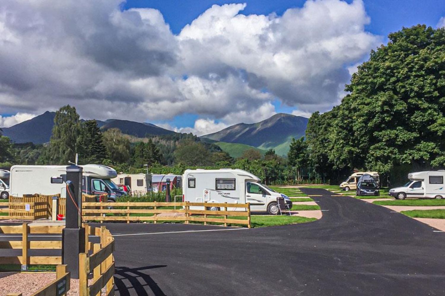 Campers parked up with mountains in background - Keswick Camping & Caravanning Club Site, Lake District 