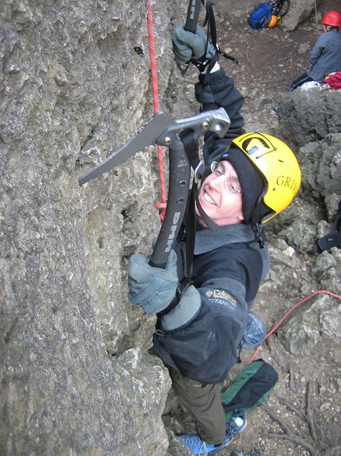 Man dry tooling , rock climbing with axes without snow