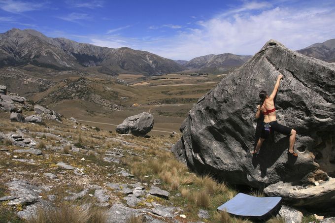 A woman bouldering out doors