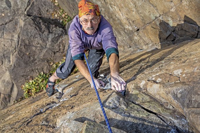 An old man top rope climbing
