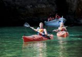 couple canoeing by cave