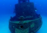 suspended diver above shipwreck