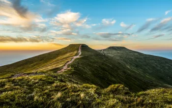 Header   Footpaths along hills with cloudy blue sunset sky background Climbing Pen y Fan CREDIT Jonathan Wakelin iStock