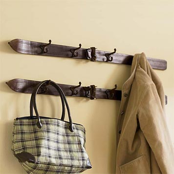 A pair ancient looking skis have become a coat rack for your nanna to hang her shopping bag on