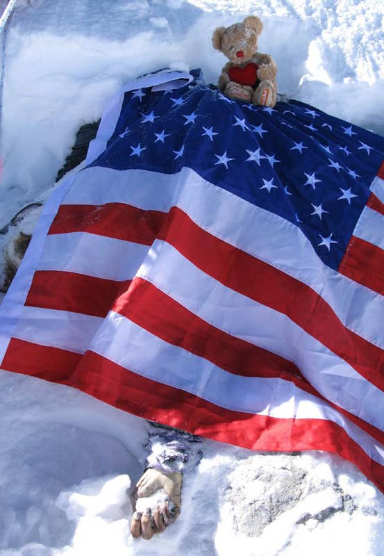 Francys Arsentiyev's body shrouded by an American flag