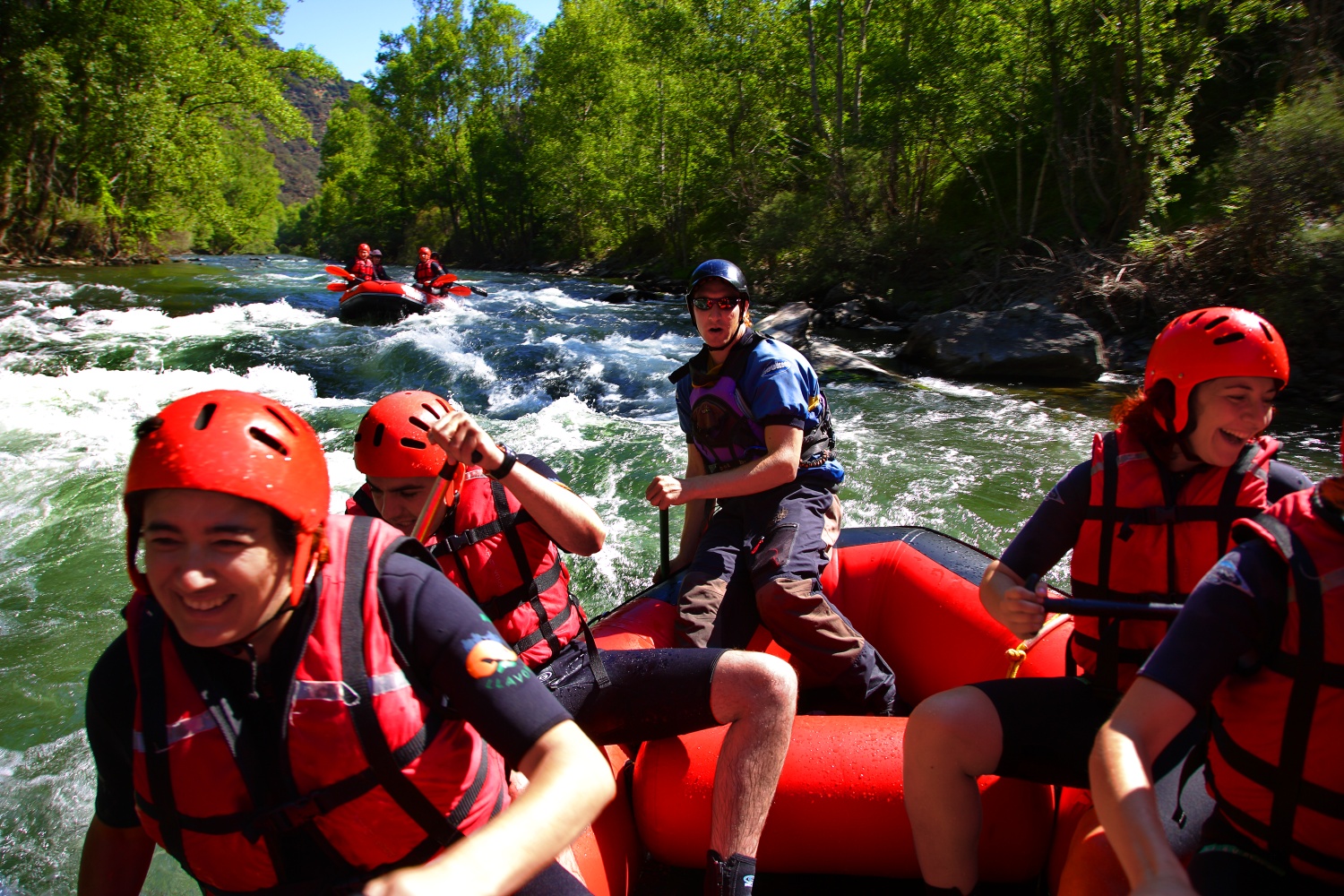 Action shot of people in boat doing white water rafting, Catalonia