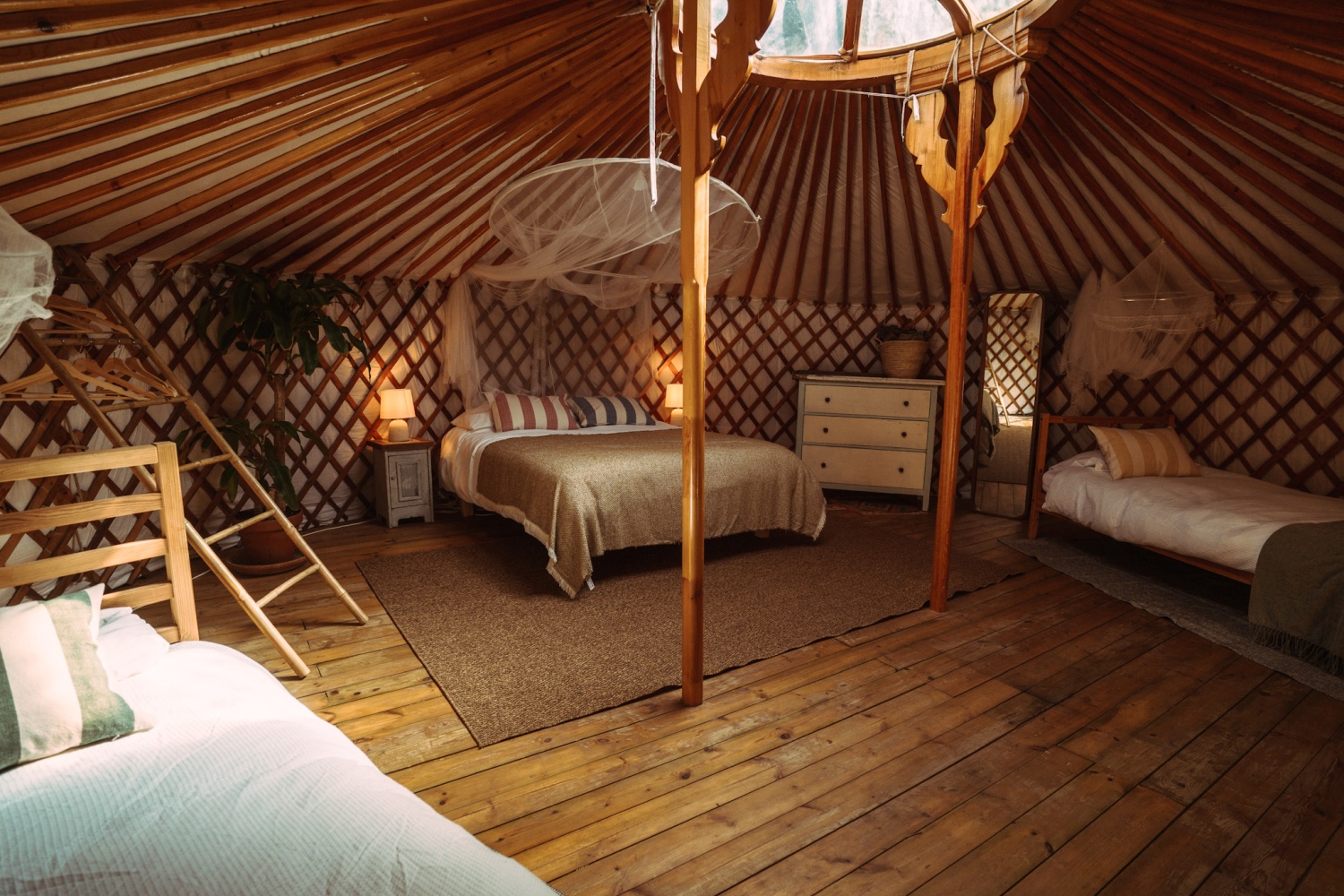 Beds in wooden yurt shaped room