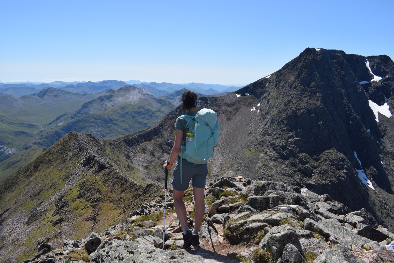 Climber looking our at mountain range on top of Ben Nevis - Ben Nevis, Scotland