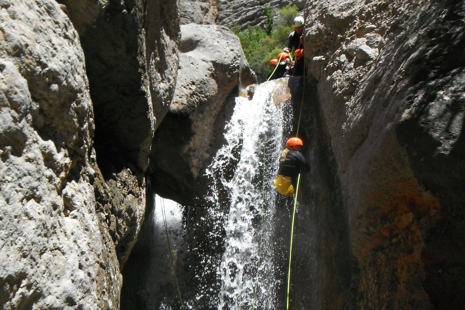 Group abseiling down a waterfall, Catalonia
