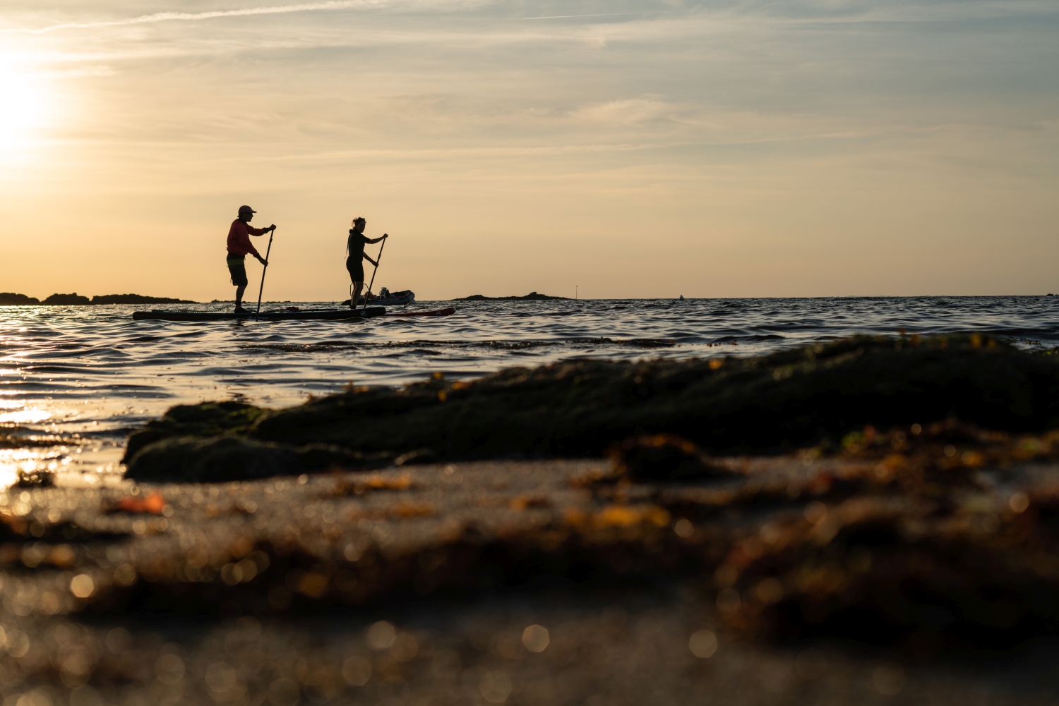 People on stand up paddleboards on ocean - Brittany, France