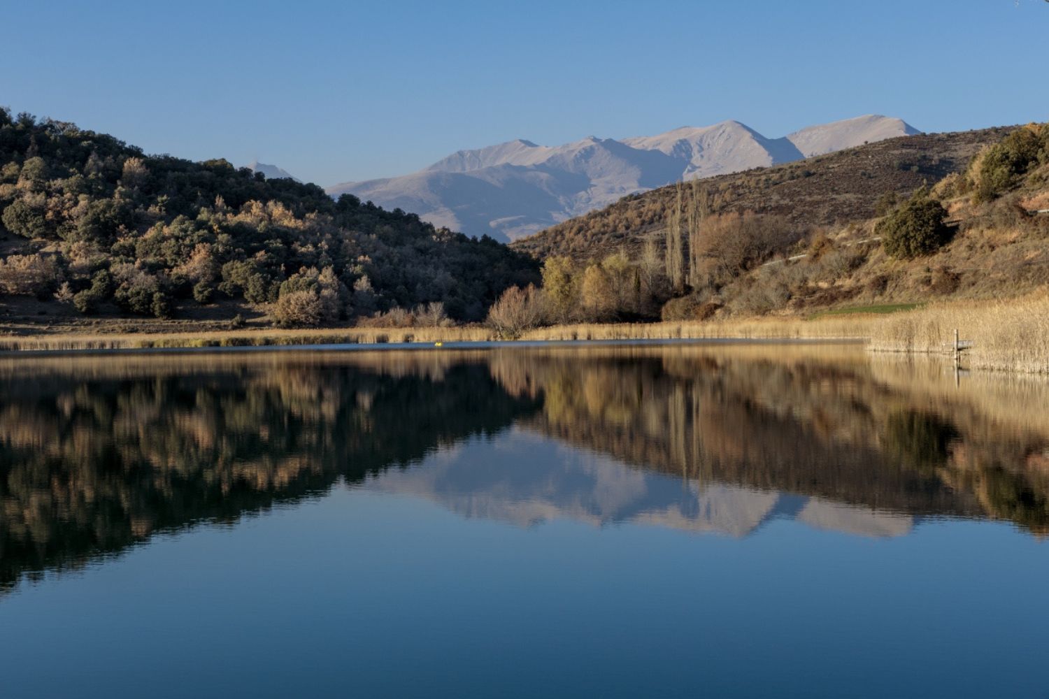 Mountains in background reflecting on The Fifth Lake - Senterada, Catalonia
