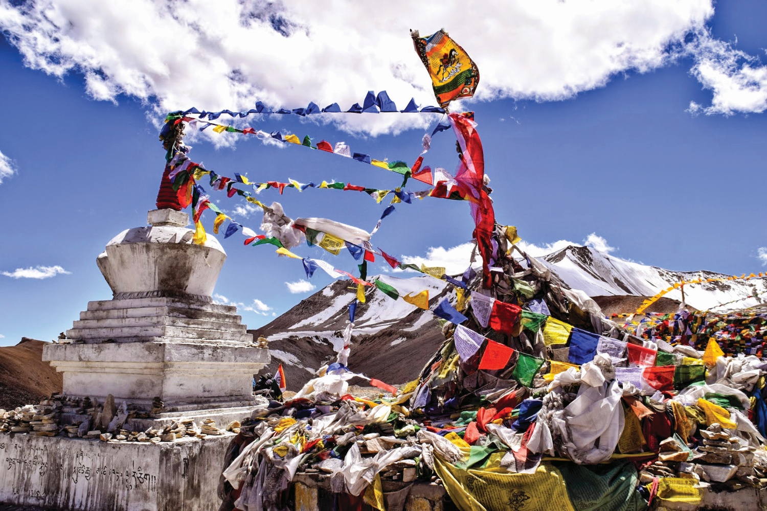 Statue covered with Buddhist prayer flags, Himalayan Mountains