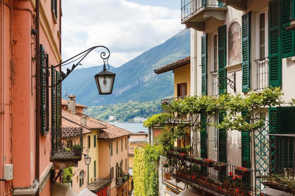 a glimpse of lake como down a bellagio street