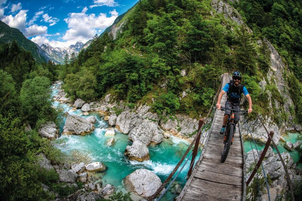crossing the shimmering turquoise river below andy lloyd