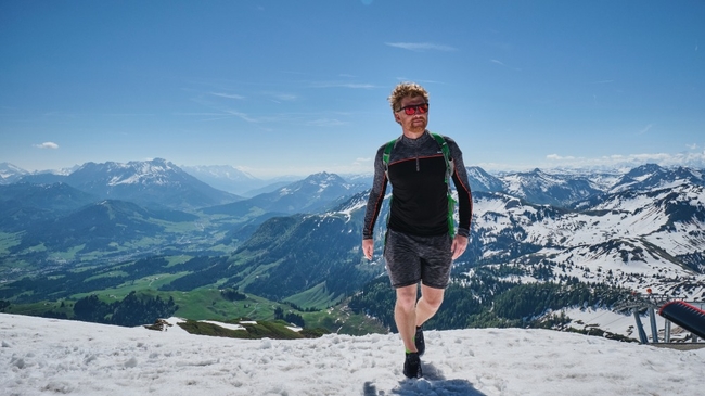 Dave soaks up some sunshine on top of Mount Hahnenkamm, ready to paraglide back down © Daniel Wildey_web.jpg