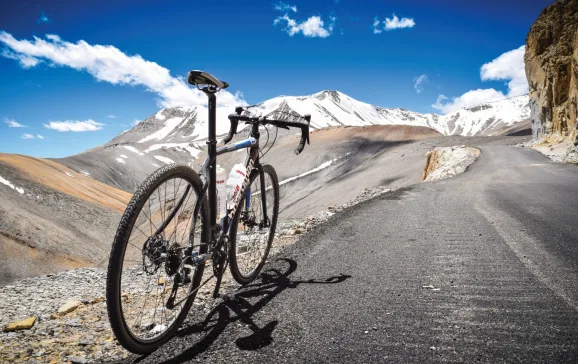 Bike standing next to road with mountains in background Himalayan Highway CREDIT Matt Westby
