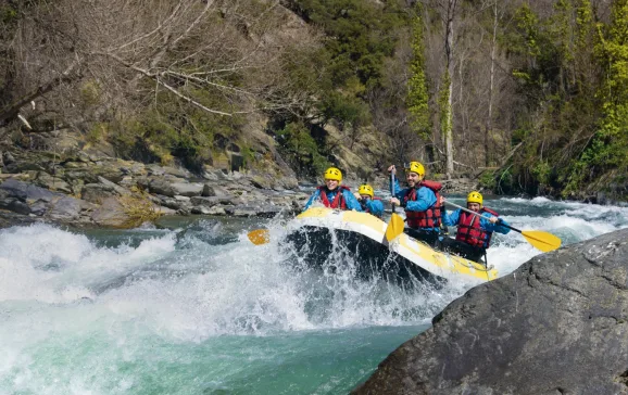 Group of people going over rapids whilst white water rafting CREDIT Catalonia Tourism white water
