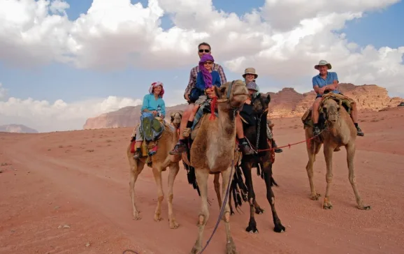 all the family on camels in wadi rum