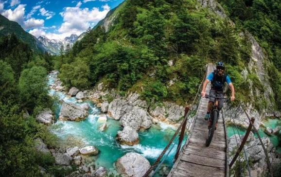 crossing the shimmering turquoise river below andy lloyd