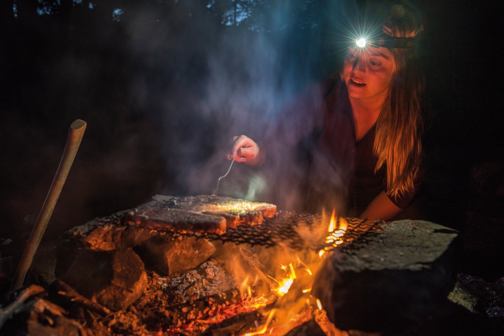 Kearie cooking up a feast on the campfire.jpg
