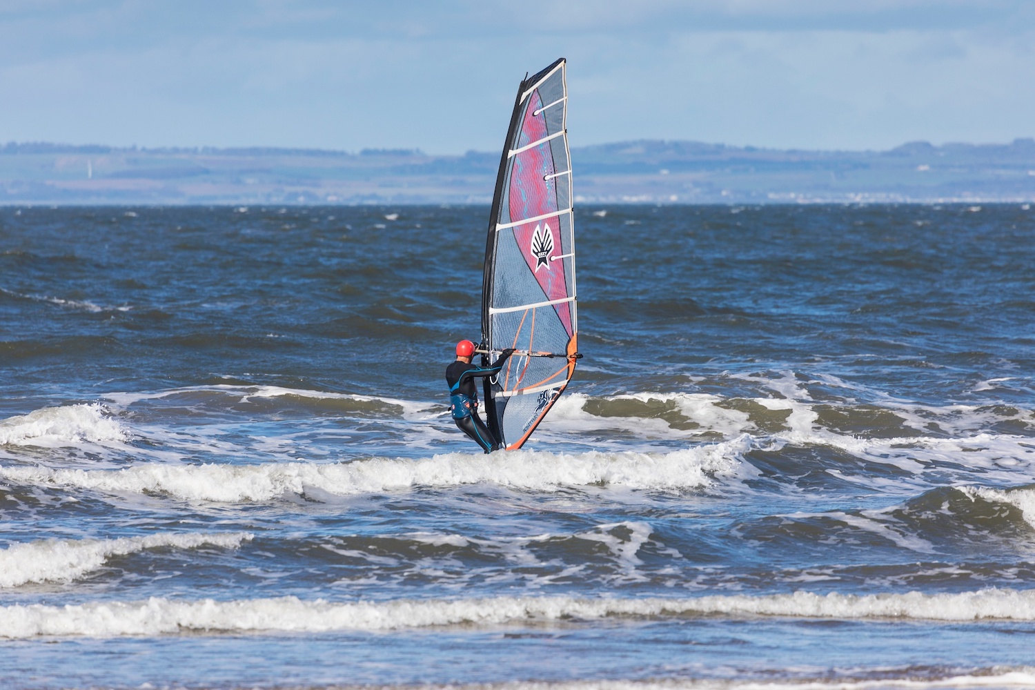 Man windsurfing on sea, East Lothian