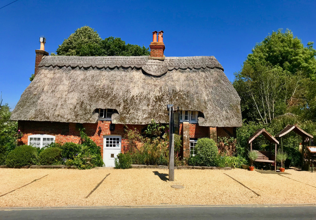 Large red brick cottage with thatched roof, New Forest 