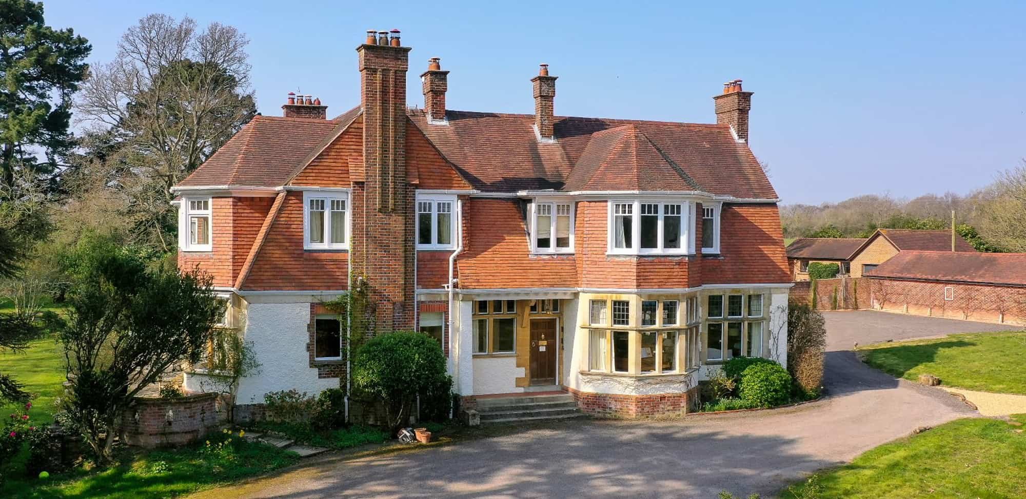 Large red brick house with lots of chimneys - Arnewood Manor, New Forest