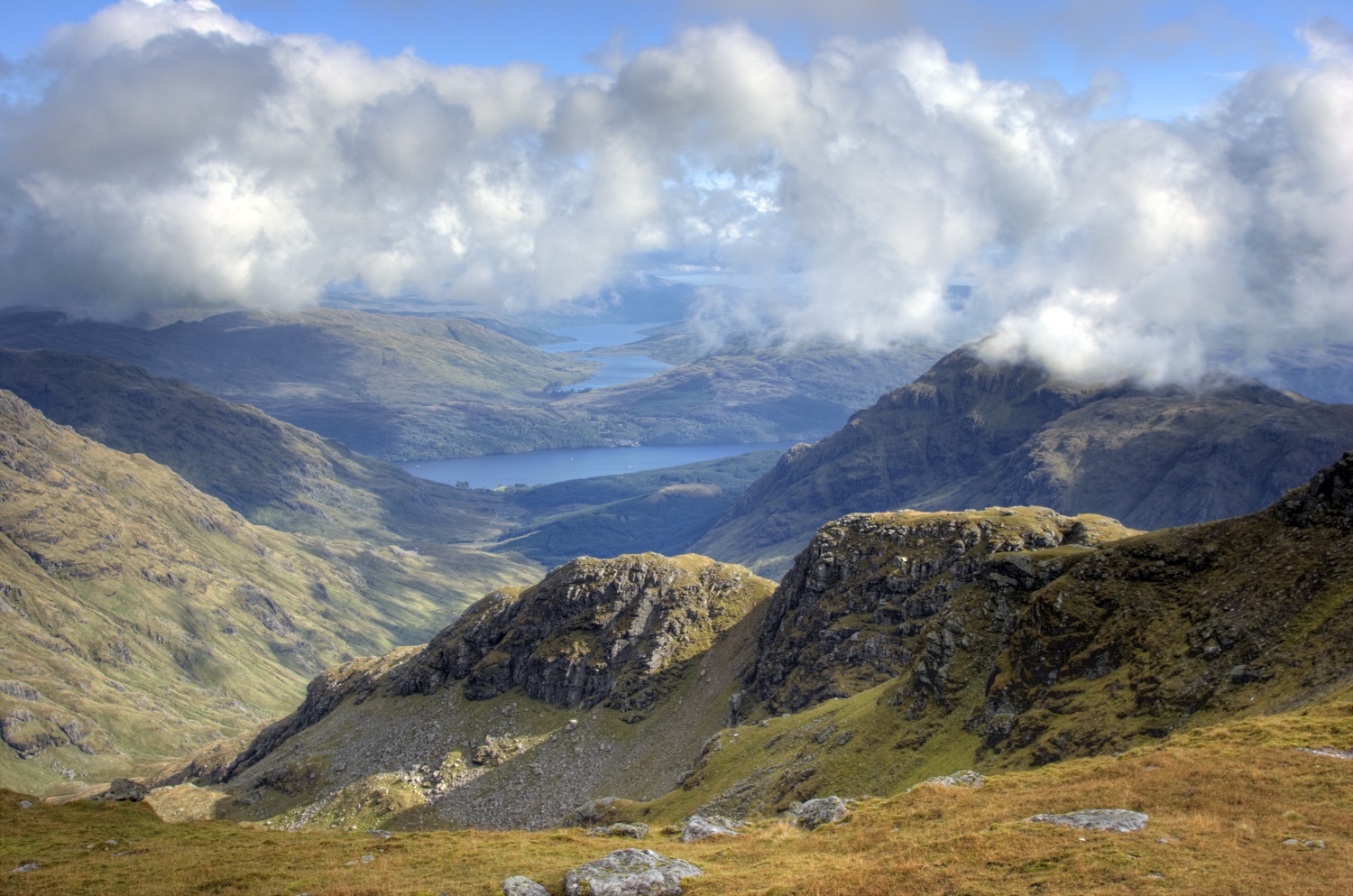 Looking from the summit of Ben Ime at valleys and lochs, West Highland Way