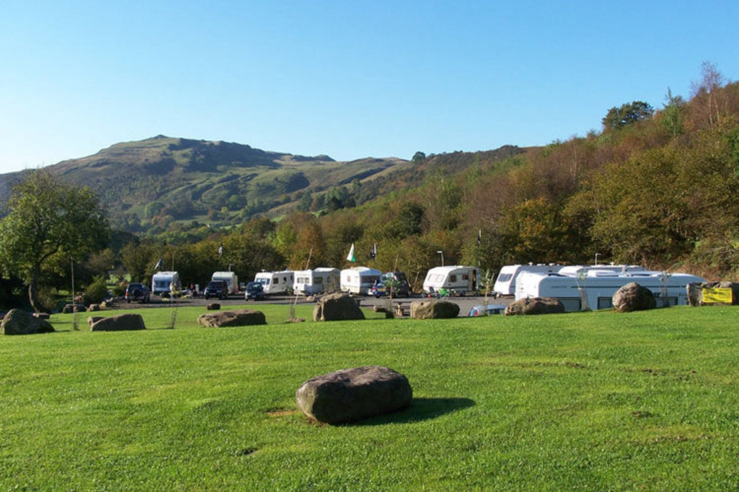 Parked up caravans next to big hill on sunny day, Brecon Beacons