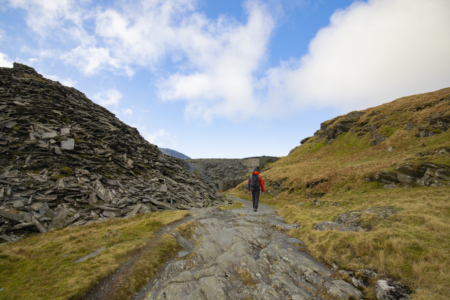 Person walking along rocky path, Snowdonia Slate Trail