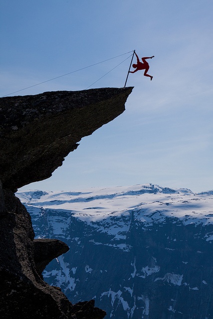 Eskil Rønningsbakken, a Norwegian artist, is doing a balancing act on the tip of the Trolltunga, Hardanger fjord, Norway. There is about 300 meters to the ground under him. Photo by Dag Endre Opedal