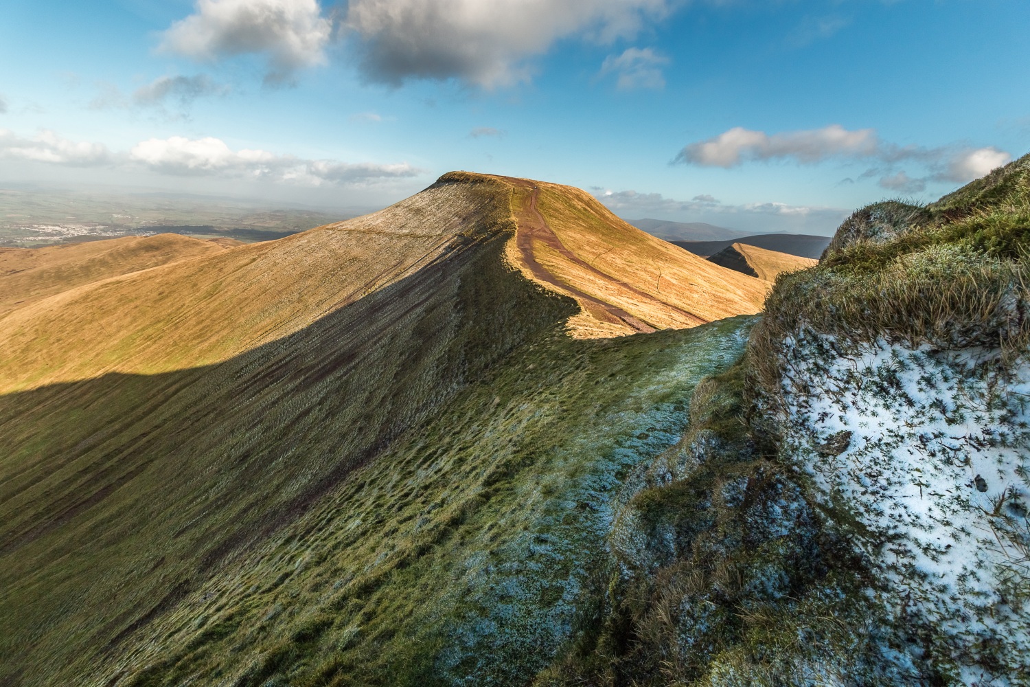 Peak of Pen y Fan with frosty grass and blue skies - Climbing Pen y Fan